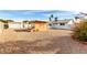 Backyard view featuring covered patio, desert landscaping, and a storage shed at 1640 W Charleston Ave, Phoenix, AZ 85023