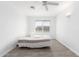 Well-lit bedroom features a neutral color scheme, tile flooring, and a window at 1640 W Charleston Ave, Phoenix, AZ 85023