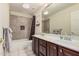 Bathroom features include double sinks, framed mirror and shower with decorative tile at 16811 S 11Th Way, Phoenix, AZ 85048