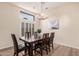 This dining room features wood-look floors, bright lighting, and a large window with shutters at 16811 S 11Th Way, Phoenix, AZ 85048