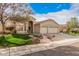 Well-maintained single-story home with lush green lawn, desert landscaping, and two-car garage on a sunny day at 16811 S 11Th Way, Phoenix, AZ 85048