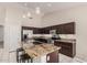 Beautiful kitchen with dark wood cabinetry, stainless steel appliances, and granite countertops at 16811 S 11Th Way, Phoenix, AZ 85048