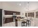 Open concept kitchen featuring granite counters, dark cabinets and stainless appliances at 16811 S 11Th Way, Phoenix, AZ 85048