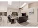 Bright living room showcasing tile floors, leather sofas, and a large window at 16811 S 11Th Way, Phoenix, AZ 85048