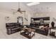 Spacious living room featuring leather sofas, a ceiling fan, and a skylight at 16811 S 11Th Way, Phoenix, AZ 85048