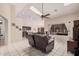 Open concept living room with view to kitchen, leather seating, and tile floors at 16811 S 11Th Way, Phoenix, AZ 85048