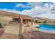 A private pool and outdoor kitchen create a backyard oasis for leisure and outdoor entertaining at 16811 S 11Th Way, Phoenix, AZ 85048