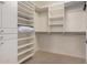 Walk-in closet featuring white built-in shelving and drawers at 16811 S 11Th Way, Phoenix, AZ 85048