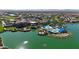 Aerial view of community clubhouse with pool, fire pit, and lush landscaping near a lake at 17555 W Glenhaven Dr, Goodyear, AZ 85338