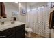 Bright bathroom features a modern vanity and a shower with stylish gold patterned curtain at 17555 W Glenhaven Dr, Goodyear, AZ 85338