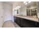 The bathroom includes a spacious vanity with double sinks and granite countertops at 17555 W Glenhaven Dr, Goodyear, AZ 85338