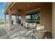 Cozy covered patio with ceiling fan and outdoor furniture, perfect for enjoying the backyard view through the large window at 17555 W Glenhaven Dr, Goodyear, AZ 85338