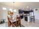 Charming dining room adjacent to the kitchen with a wooden table set and decorative chandelier overhead at 17555 W Glenhaven Dr, Goodyear, AZ 85338