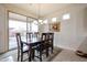 Bright dining area features sliding glass doors to the patio and is naturally lit by several windows at 17555 W Glenhaven Dr, Goodyear, AZ 85338