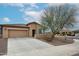 Charming single-story home with a well-manicured front yard, desert landscaping, and a spacious driveway at 17555 W Glenhaven Dr, Goodyear, AZ 85338