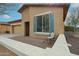 Side view of the home showcasing the brick paver patio and xeriscape landscaping at 17555 W Glenhaven Dr, Goodyear, AZ 85338