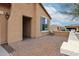 Comfortable covered patio area outside the home featuring brick flooring and stucco walls at 17555 W Glenhaven Dr, Goodyear, AZ 85338