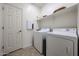 Efficient laundry room featuring modern washer and dryer units, ensuring convenience at 17555 W Glenhaven Dr, Goodyear, AZ 85338