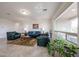 Airy living room with tile floors, large windows, and cozy furniture perfect for relaxation at 17555 W Glenhaven Dr, Goodyear, AZ 85338