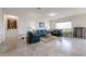 Spacious living room featuring neutral tile flooring, recessed lighting and comfortable seating at 17555 W Glenhaven Dr, Goodyear, AZ 85338