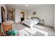 Bright main bedroom with carpet flooring and a view into the en-suite bathroom at 17555 W Glenhaven Dr, Goodyear, AZ 85338