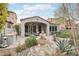 Tranquil backyard featuring a fountain, covered patio, outdoor grill, and desert plants at 18282 N 92Nd St, Scottsdale, AZ 85255