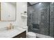 Modern bathroom showcases a glass shower with sleek black tiles and gold fixtures, exuding sophistication at 18282 N 92Nd St, Scottsdale, AZ 85255