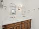 Bathroom with double sinks, quartz countertop, wood cabinets, and modern fixtures at 18282 N 92Nd St, Scottsdale, AZ 85255