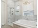 Elegant bathroom featuring a soaking tub, a glass-enclosed shower and modern fixtures at 18282 N 92Nd St, Scottsdale, AZ 85255