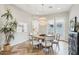 Inviting dining room with a round table, stylish chandelier, and herringbone wood floors at 18282 N 92Nd St, Scottsdale, AZ 85255