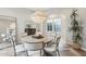 Bright dining room with a round table, modern chandelier, and beautiful hardwood floors at 18282 N 92Nd St, Scottsdale, AZ 85255