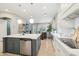 Open-concept kitchen with white cabinets, a central island, and a view into the living room at 18282 N 92Nd St, Scottsdale, AZ 85255