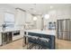 Bright kitchen featuring white cabinets, stainless steel appliances, and a large center island with bar seating at 18282 N 92Nd St, Scottsdale, AZ 85255