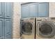 Well-organized laundry room featuring LG washer/dryer set and blue cabinets, offering both functionality and style at 18282 N 92Nd St, Scottsdale, AZ 85255