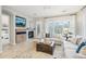 Comfortable living room with a fireplace, television, and view of the outdoor landscape at 18282 N 92Nd St, Scottsdale, AZ 85255