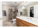 Bathroom featuring a shower, vanity, sink and mirror, and a walk-in closet at 18421 N 12Th Way, Phoenix, AZ 85022