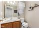 Cozy bathroom with a single sink vanity, decorative mirror, and stylish accents at 18421 N 12Th Way, Phoenix, AZ 85022