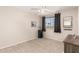 Spare bedroom featuring a ceiling fan, carpeted floor and a medium sized window at 18421 N 12Th Way, Phoenix, AZ 85022