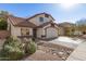 Lovely home with a tile roof, neutral stucco, rock landscaping, and a driveway leading to a two-car garage at 18421 N 12Th Way, Phoenix, AZ 85022