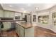 Bright kitchen featuring stainless steel appliances, an island, hardwood floors, and a large window at 18421 N 12Th Way, Phoenix, AZ 85022