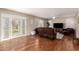 Cozy living room featuring hardwood floors, a ceiling fan, and french doors to outdoor space at 18421 N 12Th Way, Phoenix, AZ 85022