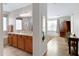 Bathroom with double sinks, a large mirror, and a doorway to a bedroom at 19025 E Raven Dr, Queen Creek, AZ 85142