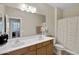 Bathroom with double sinks, a large mirror, and a shower/tub combination at 19025 E Raven Dr, Queen Creek, AZ 85142