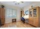 Bedroom with a desk, chair, and cabinets, creating a functional and stylish workspace at 19025 E Raven Dr, Queen Creek, AZ 85142