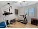 Bedroom with workout equipment, including a treadmill and pull-up bar at 19025 E Raven Dr, Queen Creek, AZ 85142