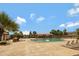 Community swimming pool with lounge chairs, palm trees, and a shaded pavilion, perfect for relaxation at 19025 E Raven Dr, Queen Creek, AZ 85142