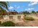 A community pool is surrounded by lounge chairs, palm trees, and a shaded gazebo for relaxation at 19025 E Raven Dr, Queen Creek, AZ 85142