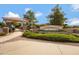 Community entrance with stone signage, manicured landscaping, and a paved walkway at 19025 E Raven Dr, Queen Creek, AZ 85142