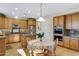 Well-lit kitchen with granite countertops, stainless steel appliances, and a cozy dining area at 19025 E Raven Dr, Queen Creek, AZ 85142