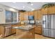 Functional kitchen with stainless steel appliances, granite countertops, and island with sink at 19025 E Raven Dr, Queen Creek, AZ 85142